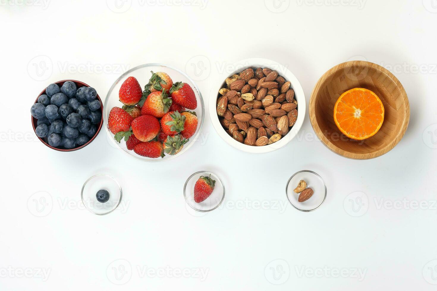 Blueberry Strawberry Herb Spice Almond Cashew Nut Mandarin Orange in bowl on white background photo