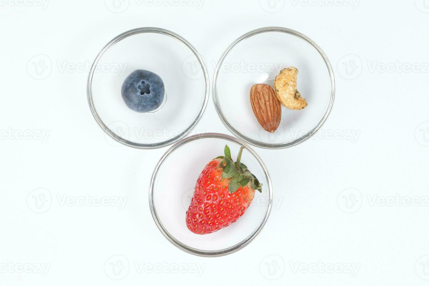 Blueberry Strawberry Herb Spice Almond Cashew Nut in glass bowl on white background photo