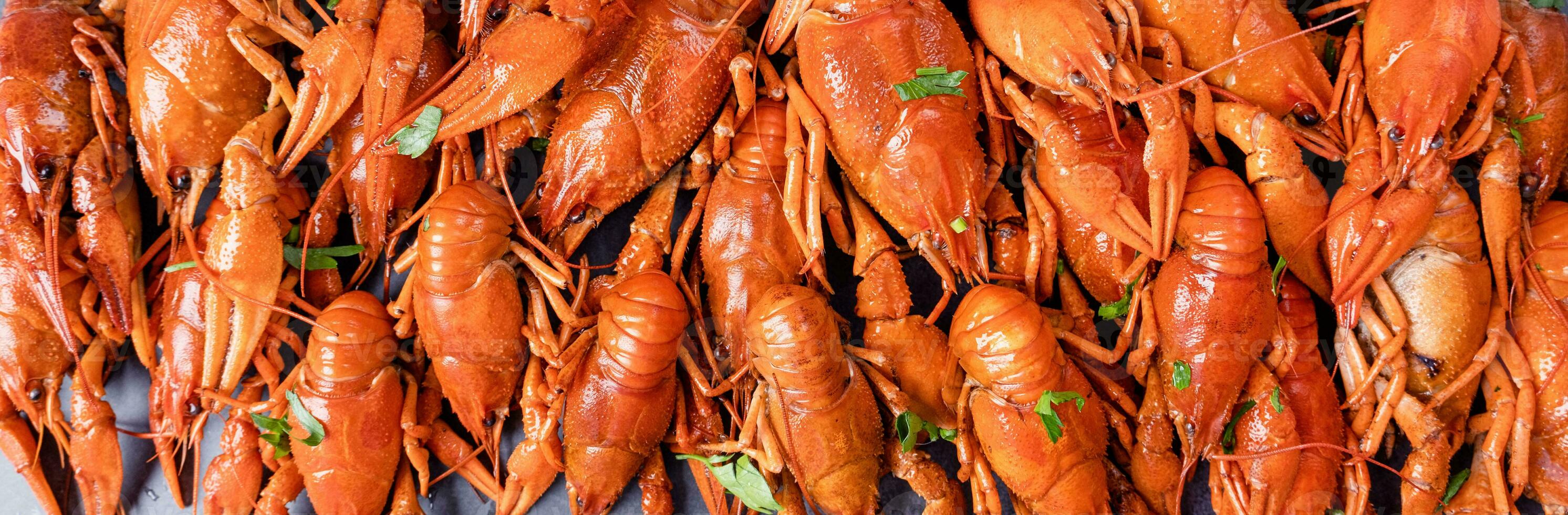 top view of cooked crawfish with lemons and spices photo