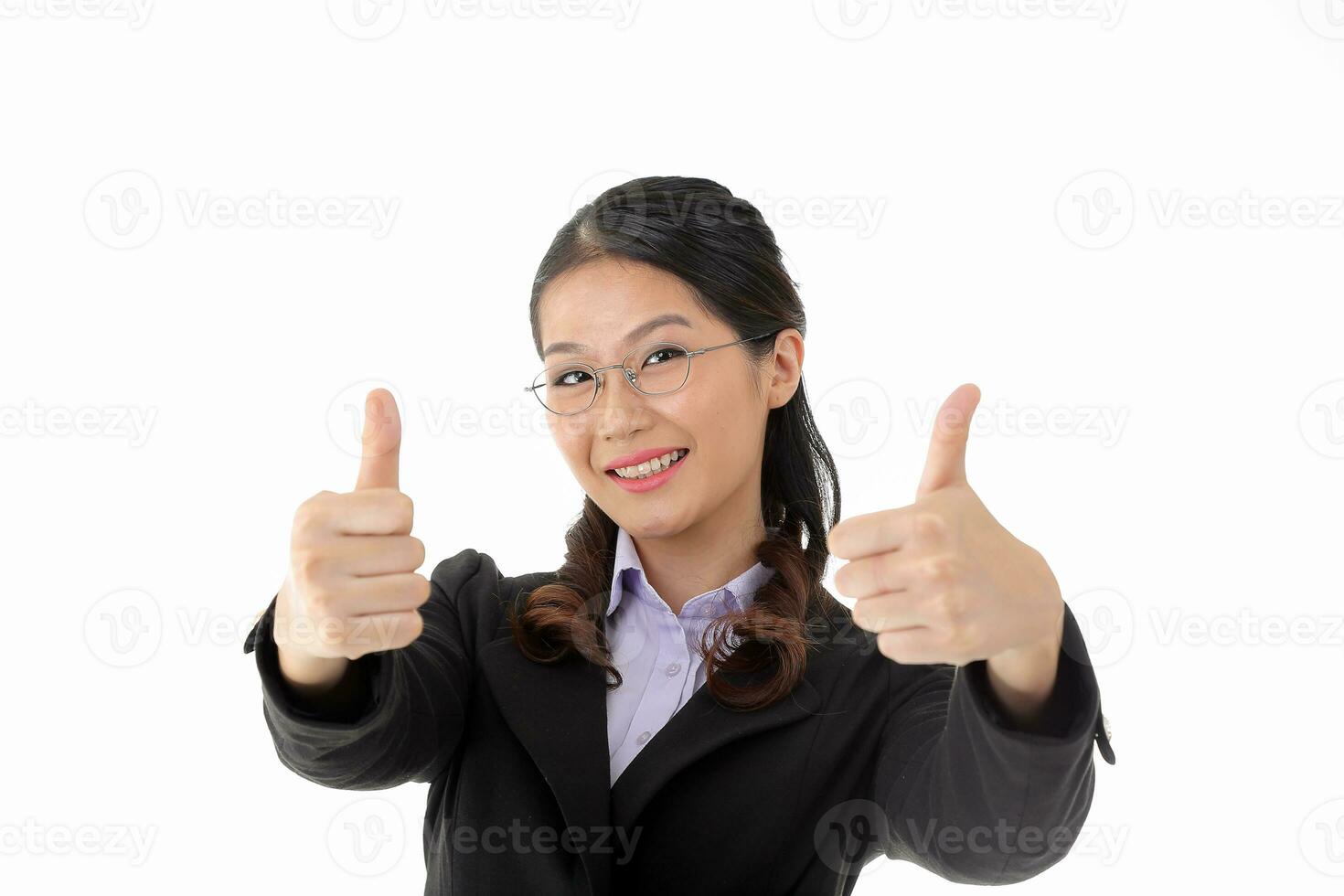 Southeast Asian young office business woman wearing suit eye spectacles look at camera smile thumbs up bot hand on white studio background photo
