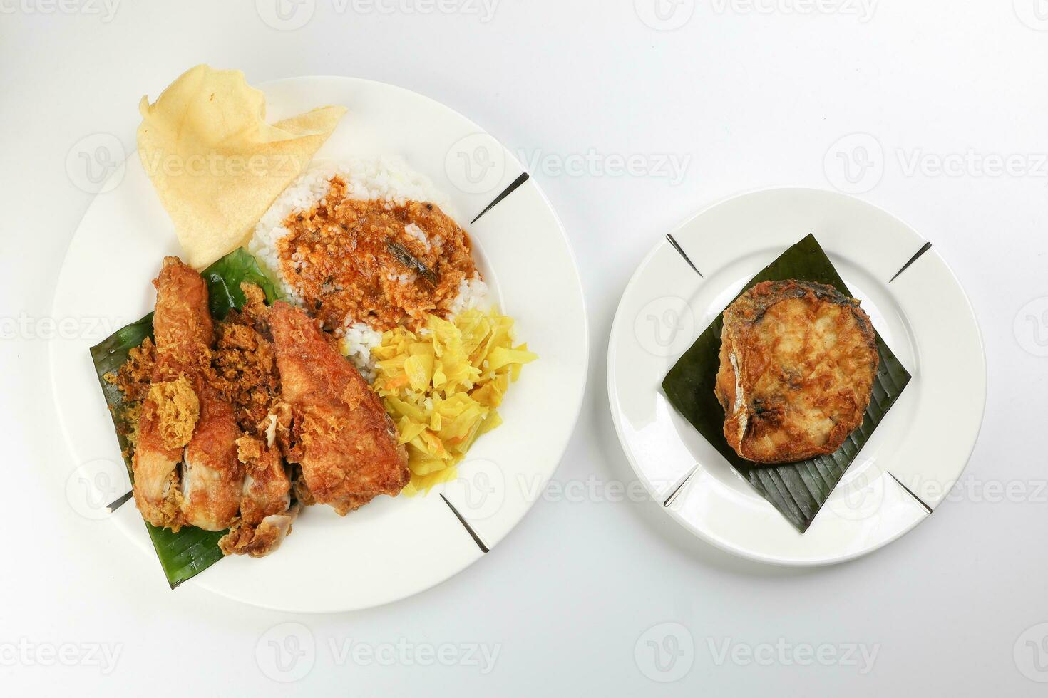 Traditional Malaysian Indian food white rice cabbage vegetable meat deep fried chopped chicken leg topped up with spicy mix gravy white background photo