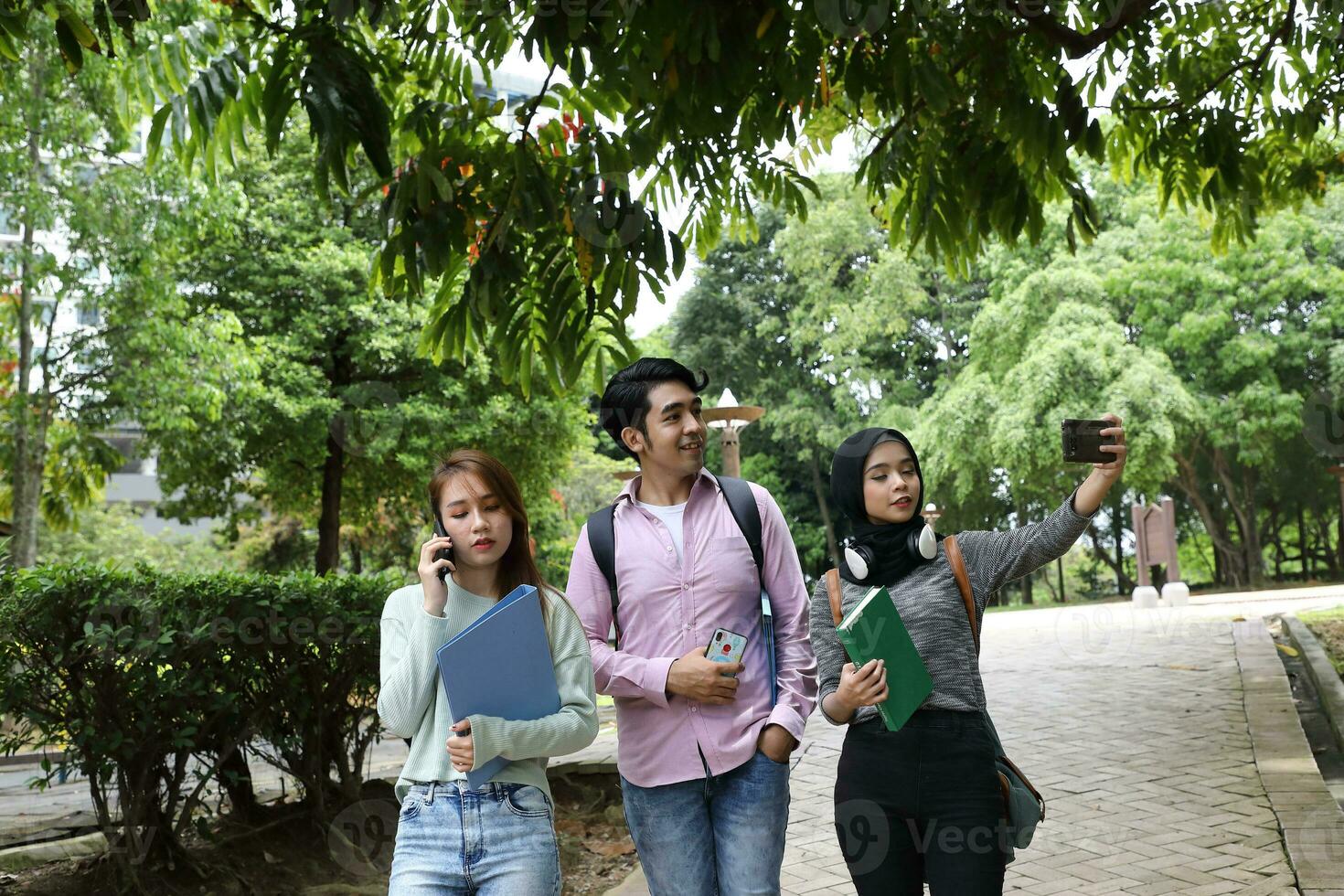 Young asian malay chinese man woman indoor stair corridor campus book file folder laptop computer phone sit stand study mingle photo