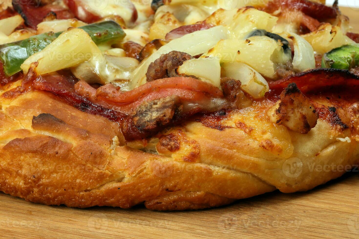 Pizza beef chicken peperoni cheese chilli capsicum onion olive on wooden board photo