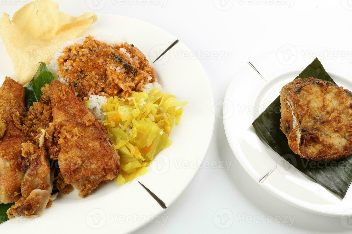 Traditional Malaysian Indian food white rice cabbage vegetable meat deep fried chopped chicken leg topped up with spicy mix gravy white background photo