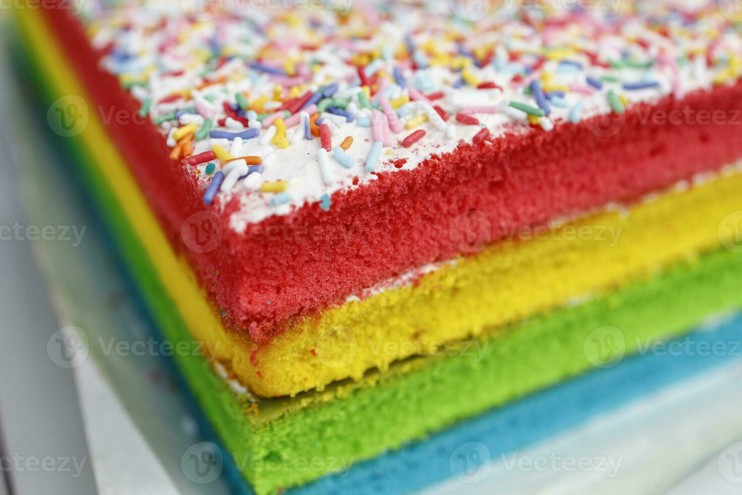Colourful layer cake with sprinkles  at weekly street market photo