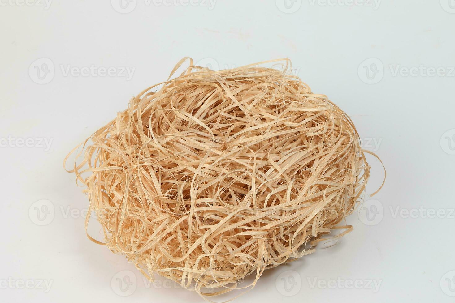 Empty bird nest hay on white background photo