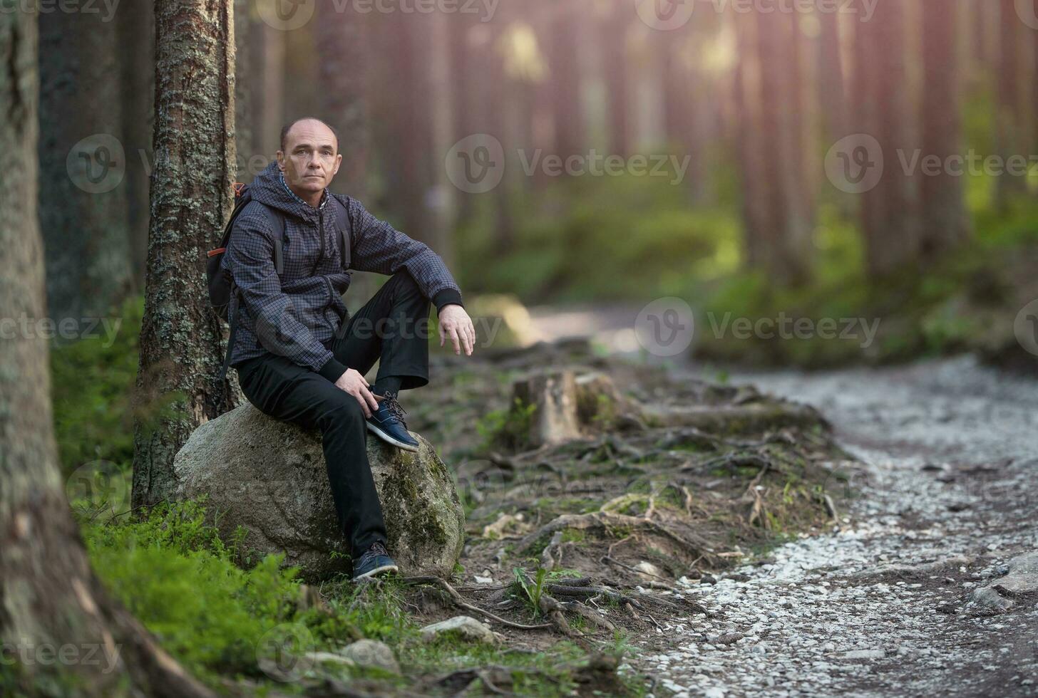 Hiker Resting on a Trail photo