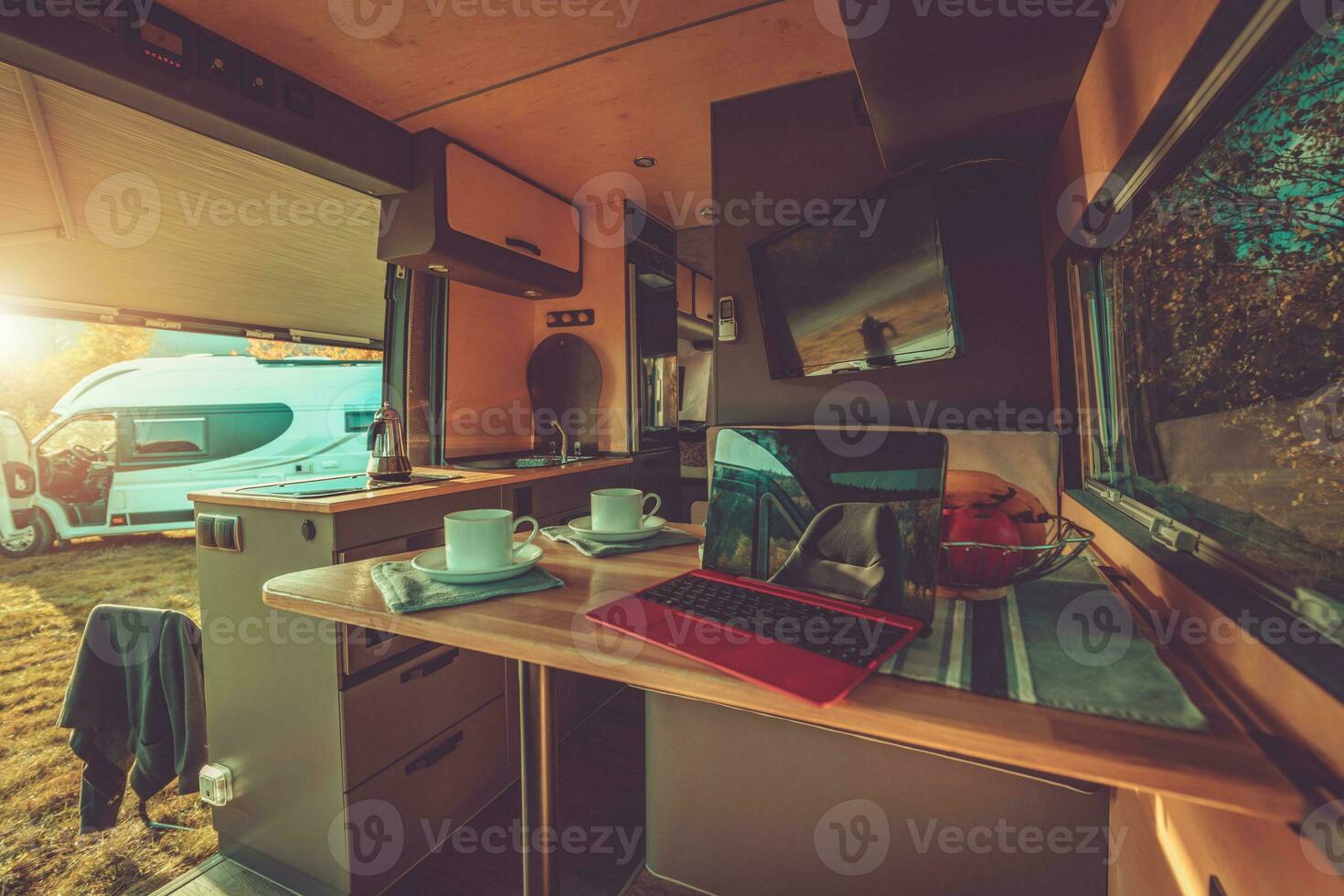Custom Built Camper Van Interior and Second RV Staying Side by Side photo