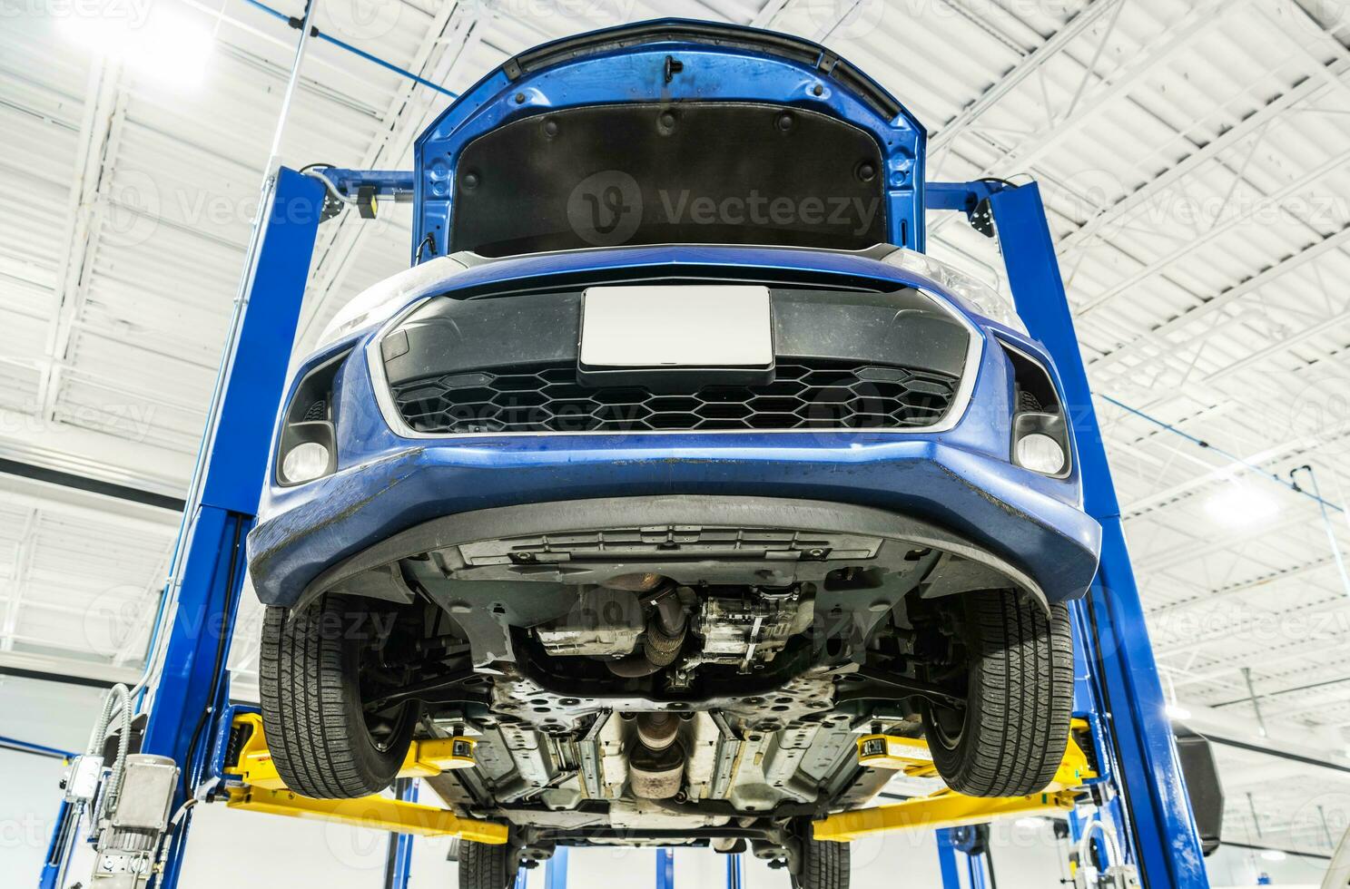 Vehicle on an Automotive Lift During Maintenance photo