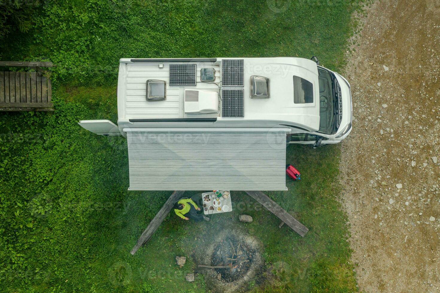 RV Park Pitch with Camper Van and Campfire Place Aerial View photo