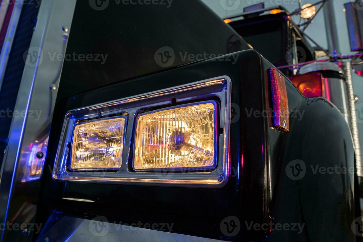 Classic Black Semi Truck Tractor Headlight Close Up photo