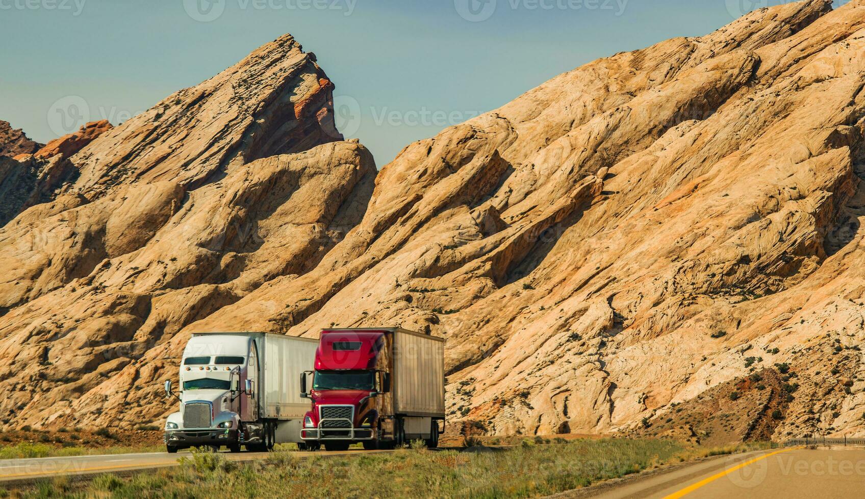 Two Semi Trucks Passing Scenic Utah Landscape photo
