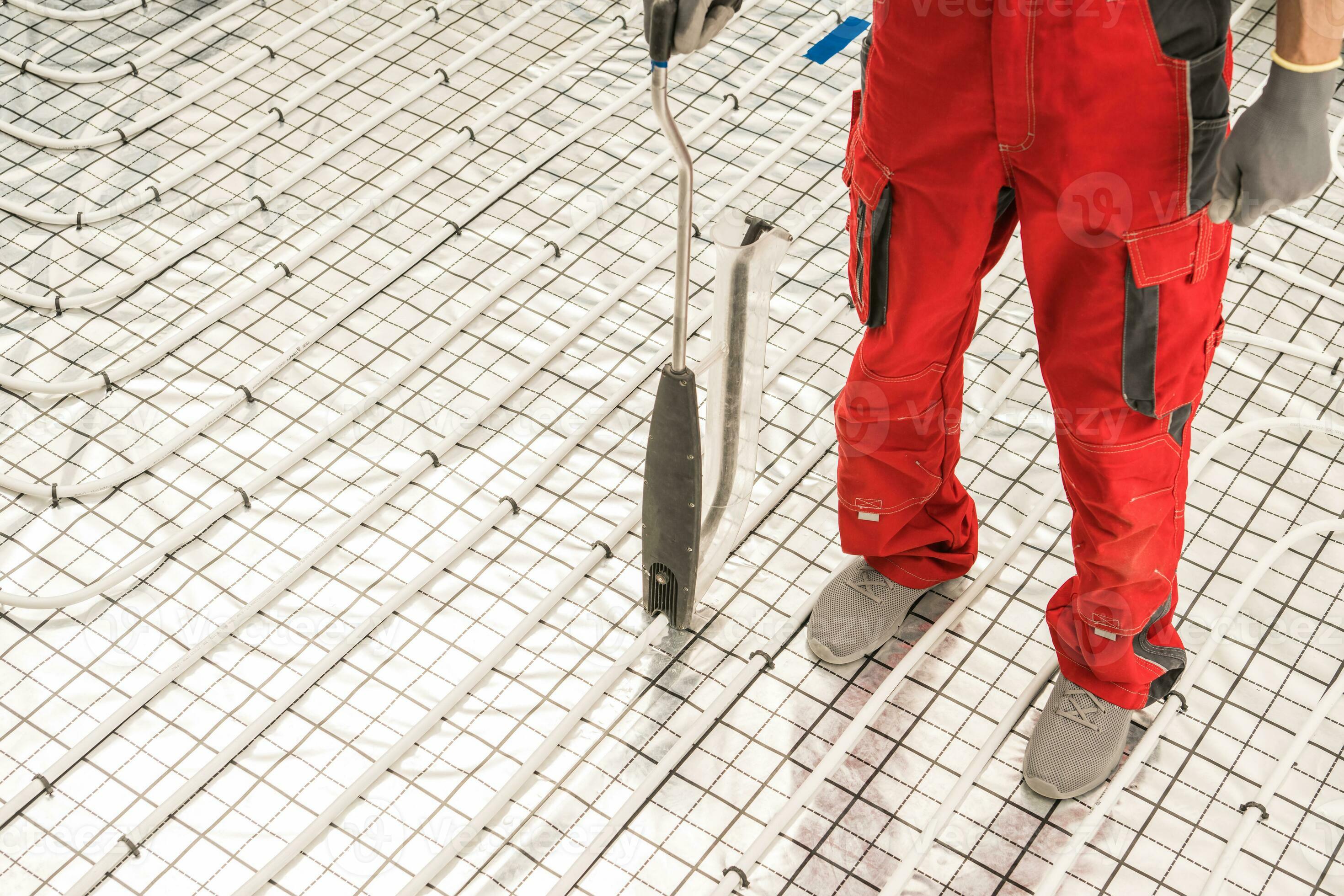 Worker Using Floor Radiant Heating Pipeline Foam Board Stapler 24520651