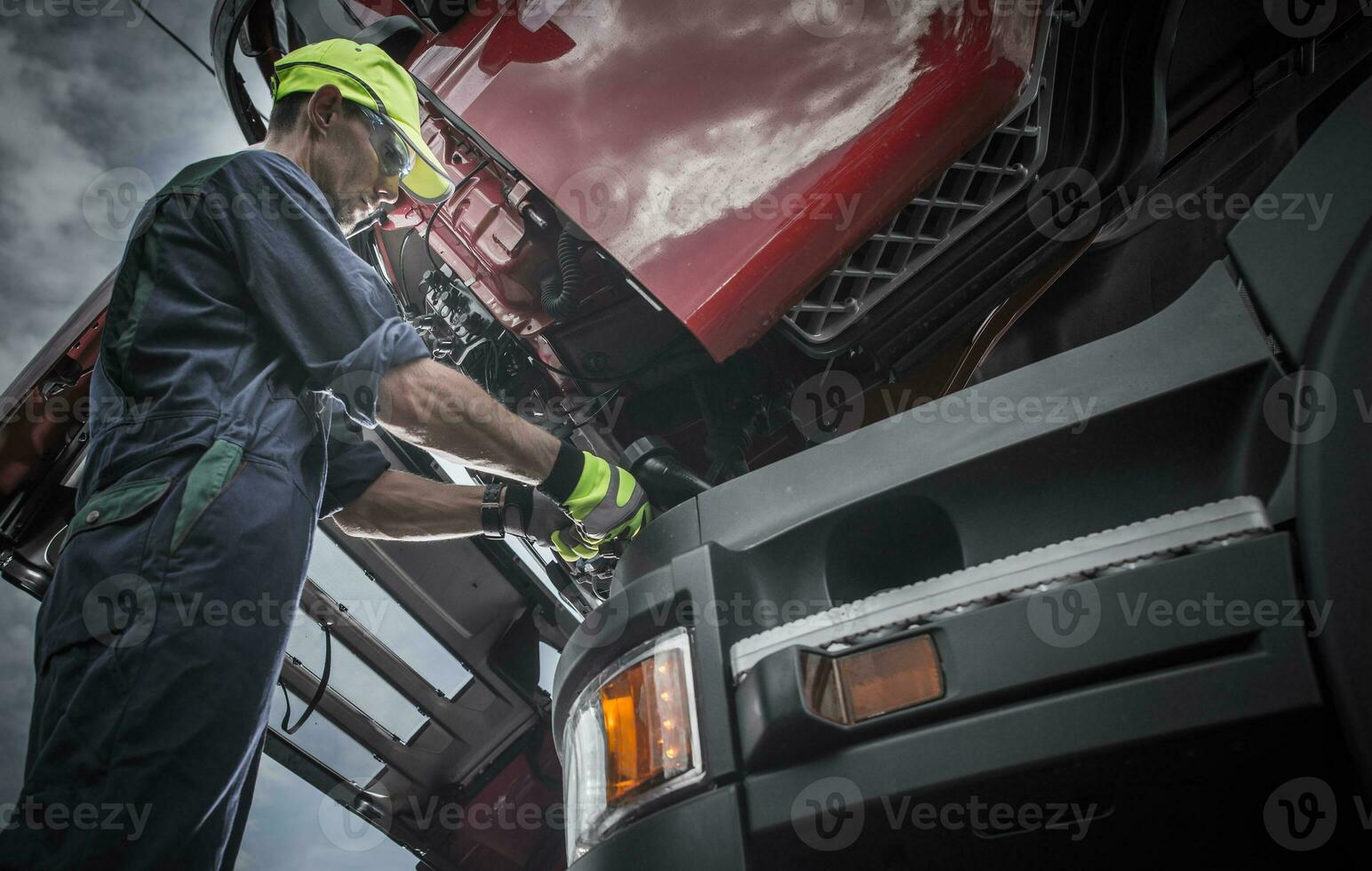 Semi Truck Professional Mechanic Servicing Vehicle photo