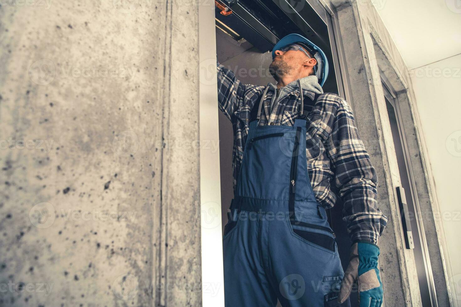 Elevator Technician Performing Scheduled Check photo