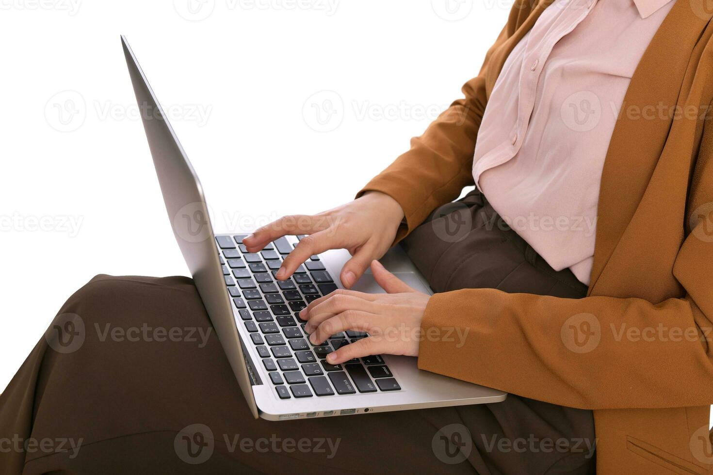 Close up of a business woman using laptop on her lap while sitting photo