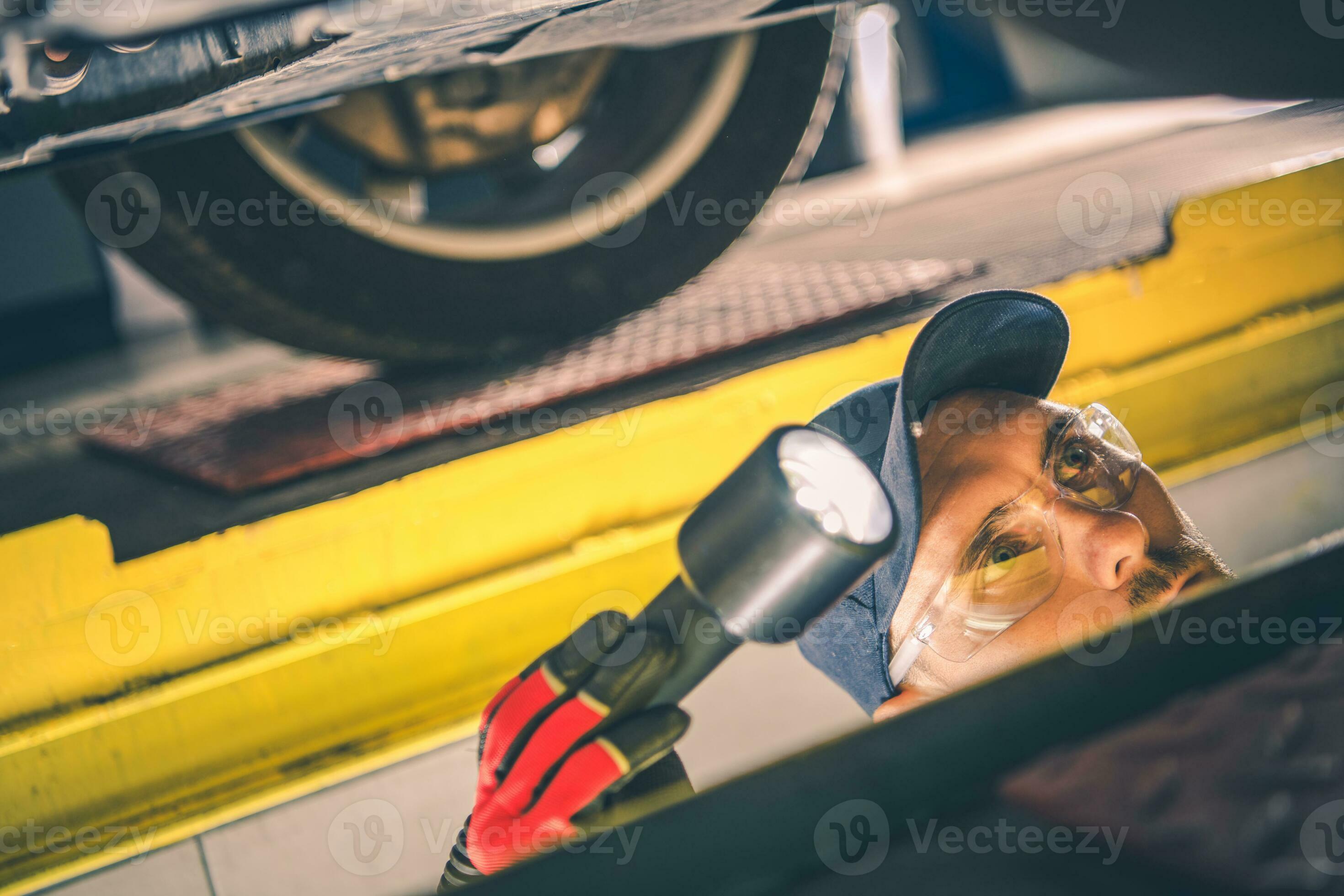 Car Mechanic Performing Vehicle Suspension Check 24523200 Stock Photo at Vecteezy
