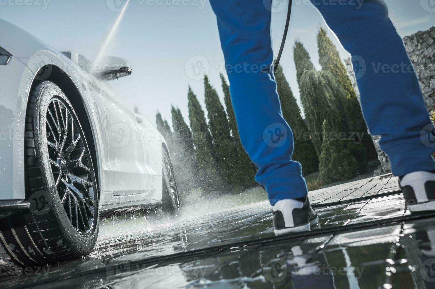 Men Pressure Washing Car photo