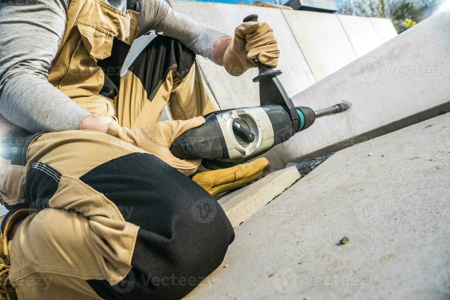 Landscaping Drilling a Hole Inside Concrete Element For a Garden LED Light Point Installation photo