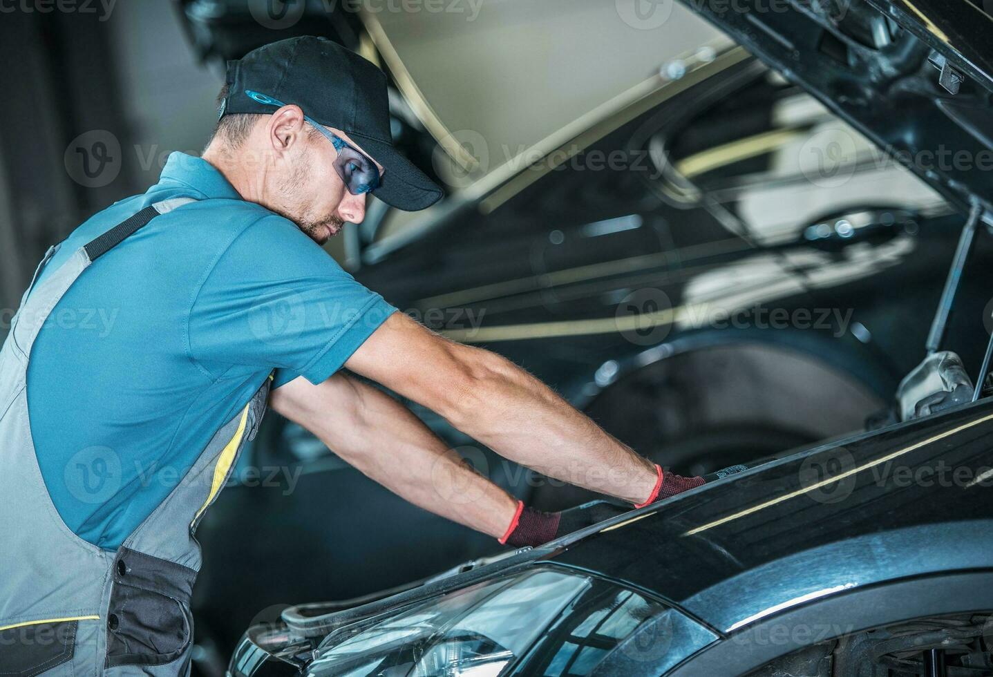 Worker Repairing Car photo