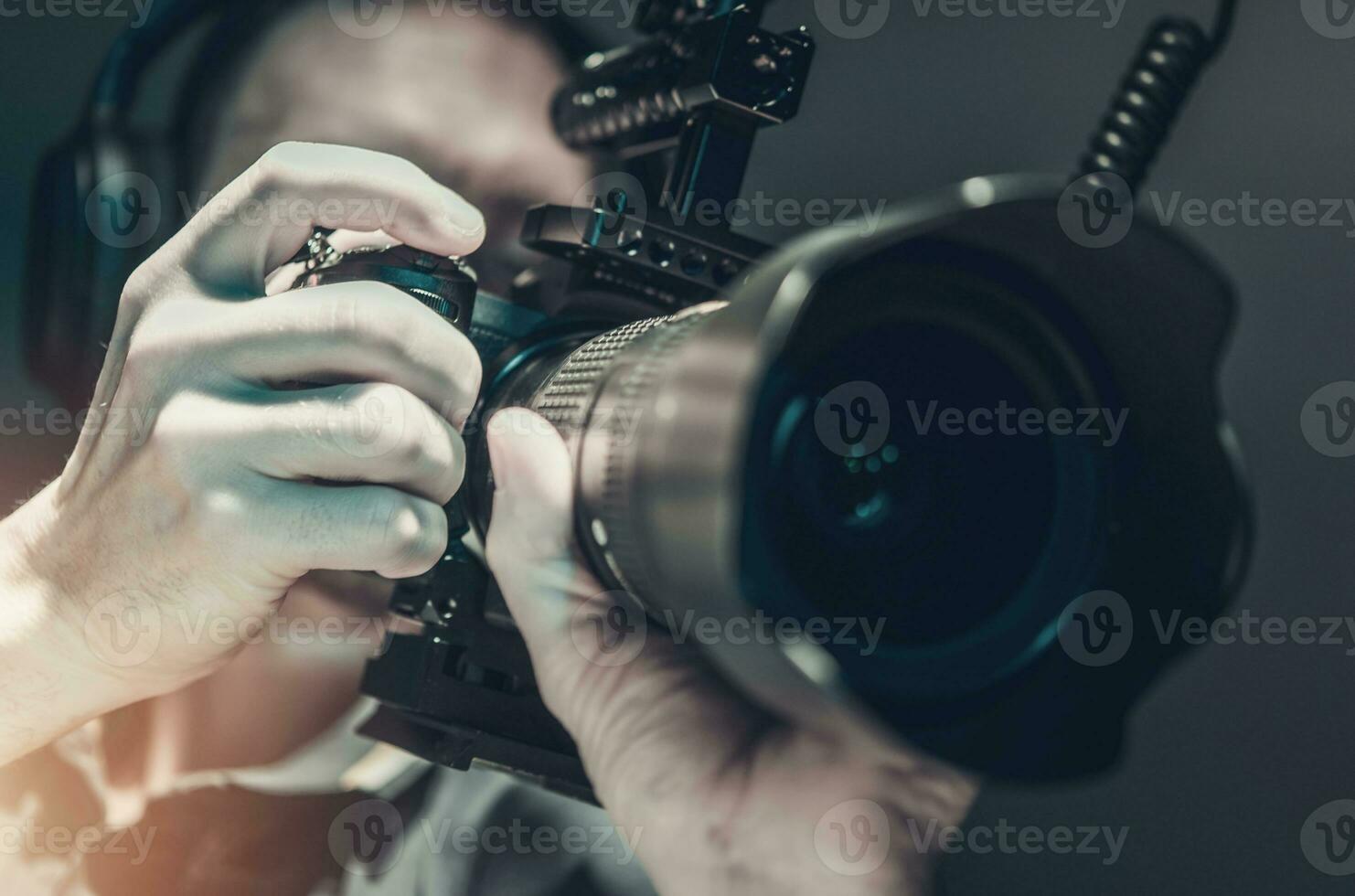 Men Taking Video Footage Handheld Using DSLR Camera photo