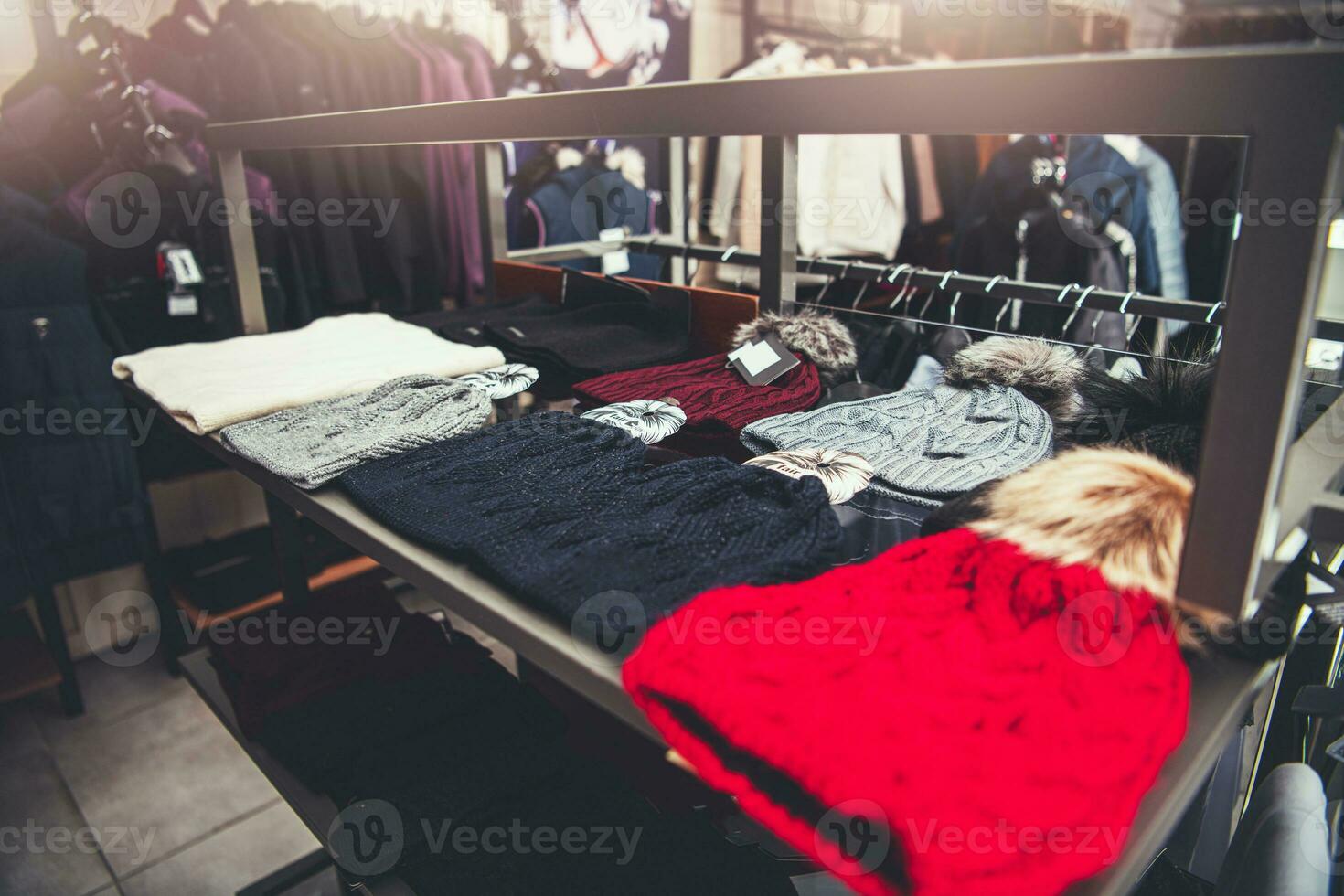 Winter Hats on the Rack Inside Clothes Retail Store photo