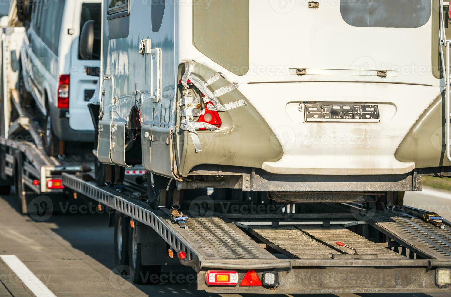 Damaged Camper Vans RV Towed Away to a Repair Shop photo