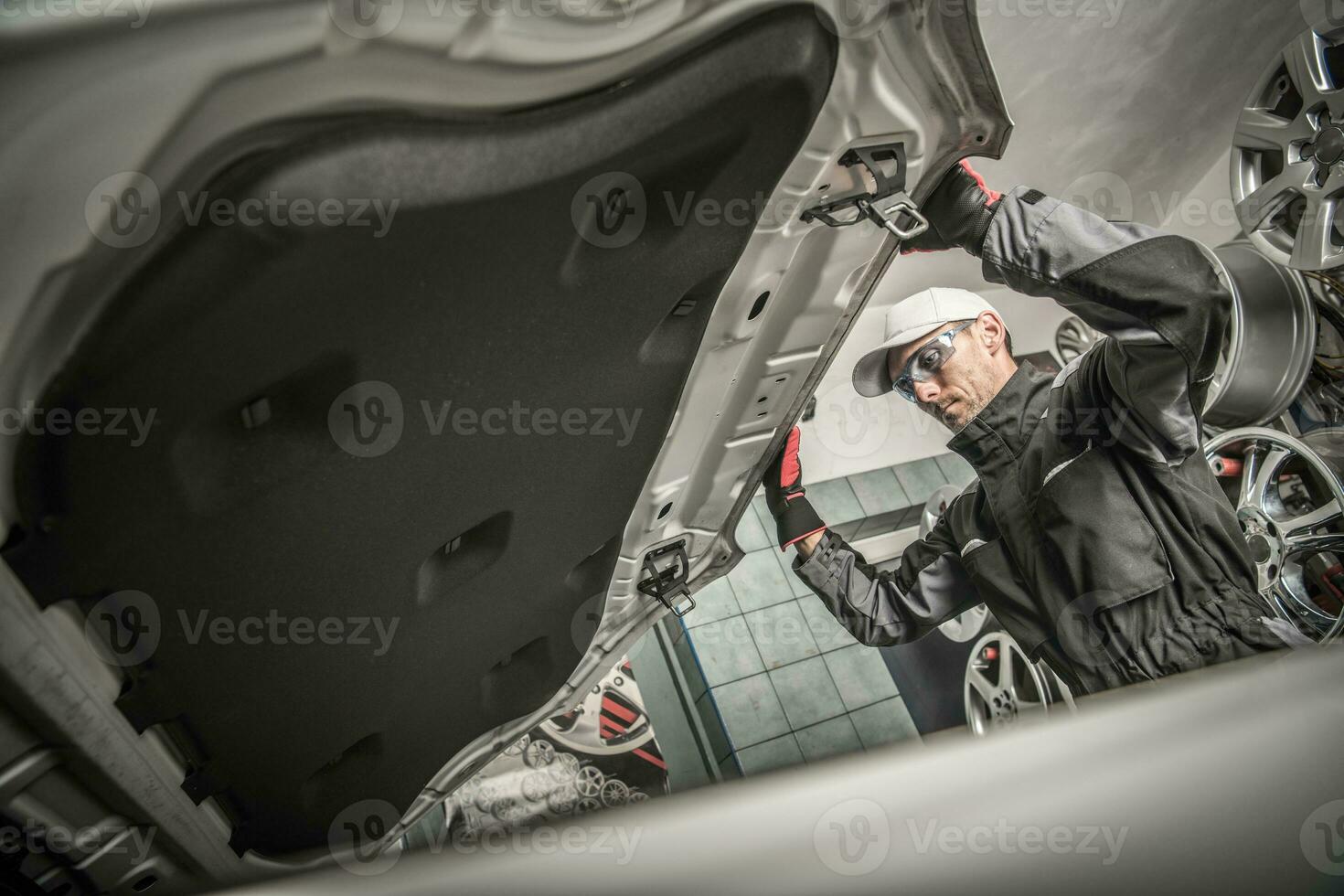 Car Mechanic Opening Hood photo