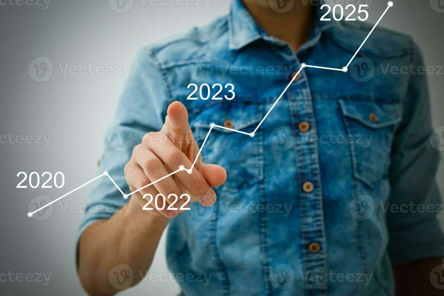 Man's hand pointing graph of success in 2023 year. Growing business concept photo