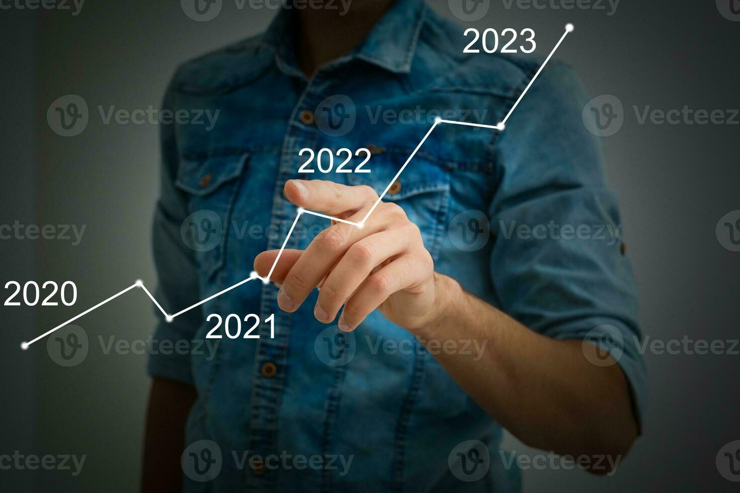 Man's hand pointing graph of success in 2022 year. Growing business concept photo