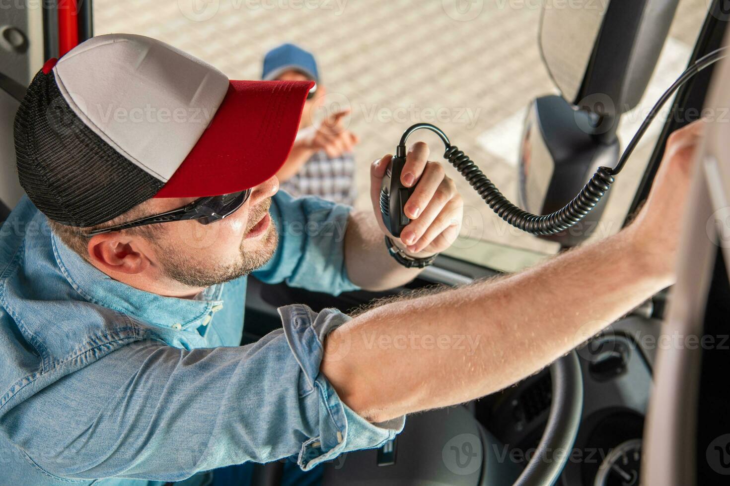 Semi Truck Driver Communicating Using CB Radio photo