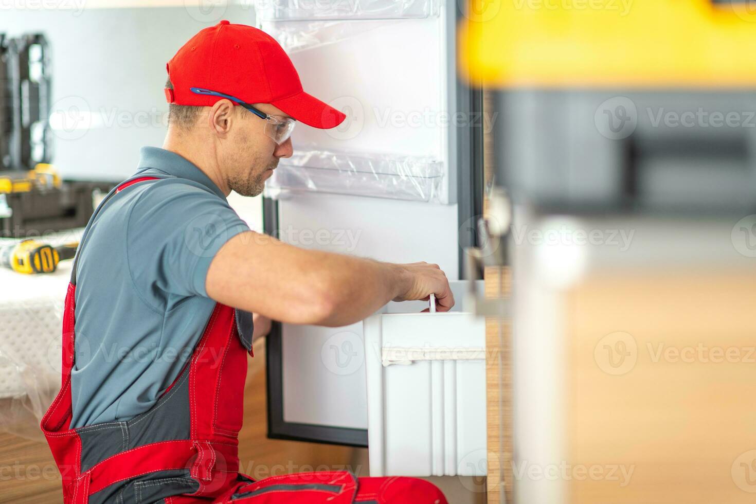 RV Center Technician Replacing Broken Motorhome Refrigerator photo