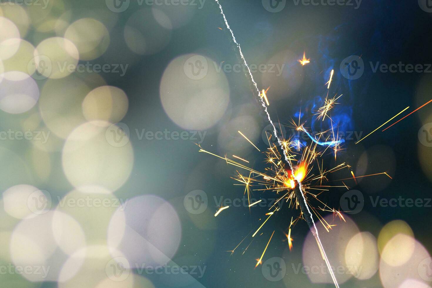 A lit sparkler showing bright sparks photo