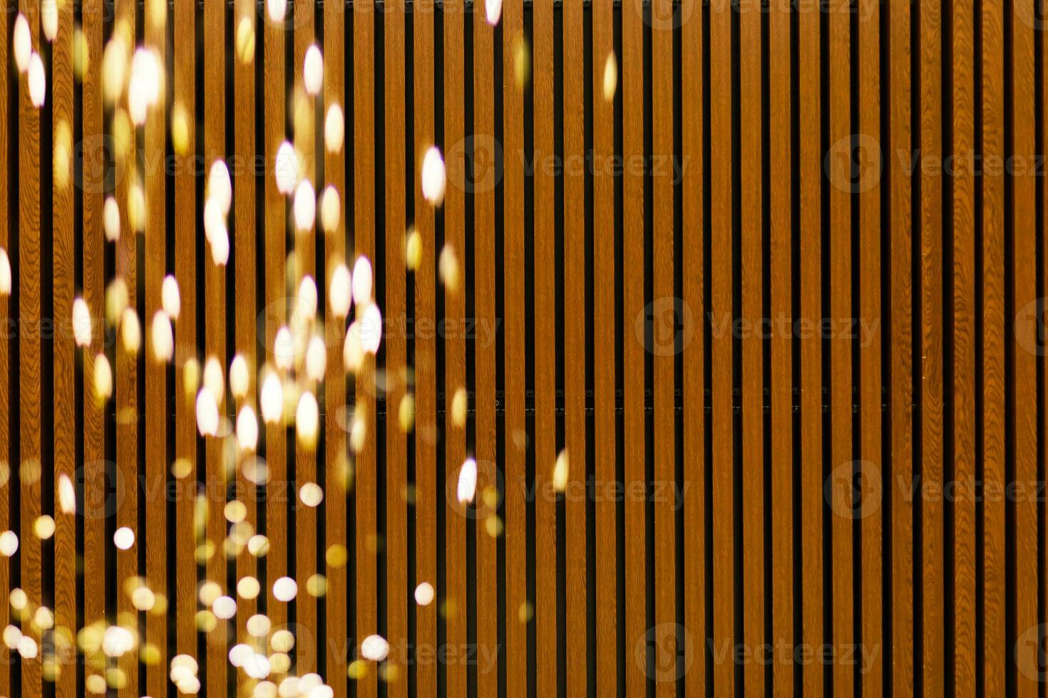 Golden bokeh lights with wooden background photo