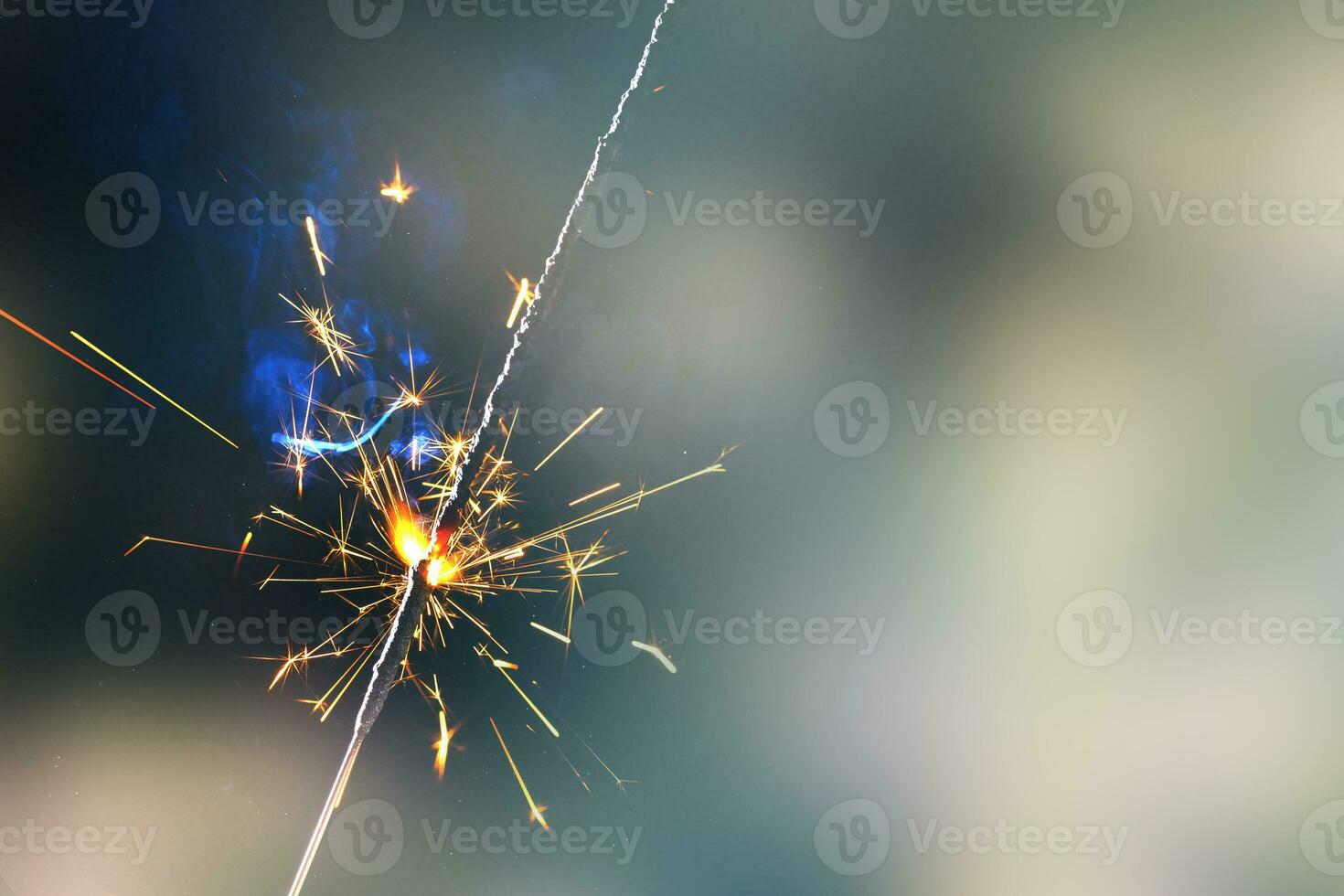 A lit sparkler showing bright sparks photo