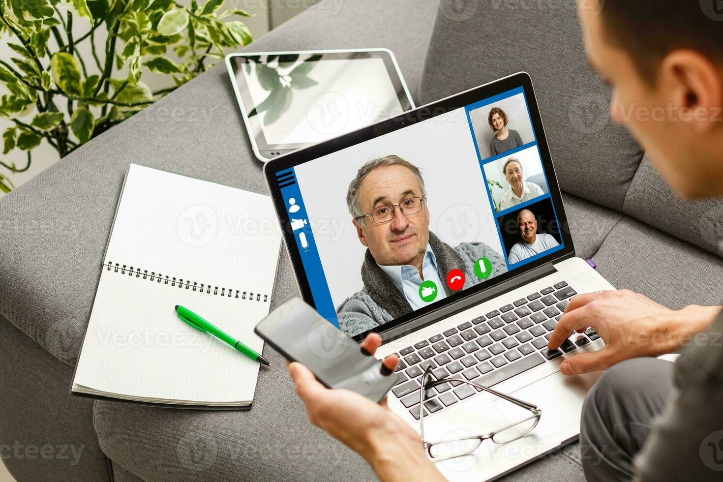 Cropped image of cheerful blogger having funny conversation with best friend in video chat on modern touchpad connecting to wireless 4G internet.Young man sharing impressions of trip on webcam photo