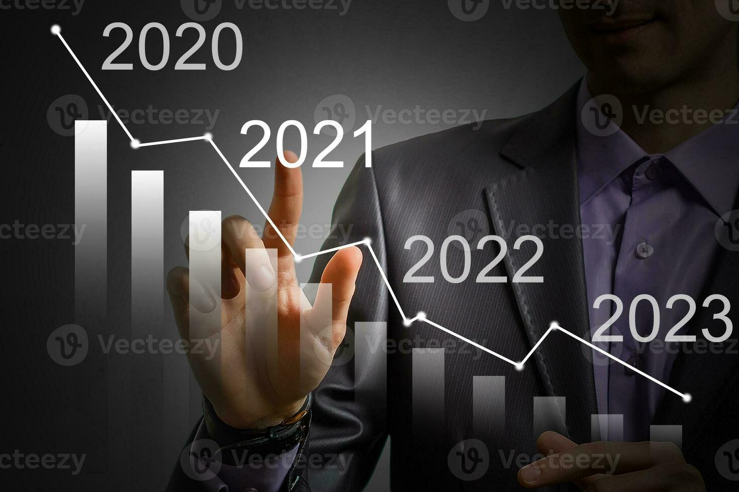 Man's hand pointing graph of success in 2021 year. Growing business concept photo