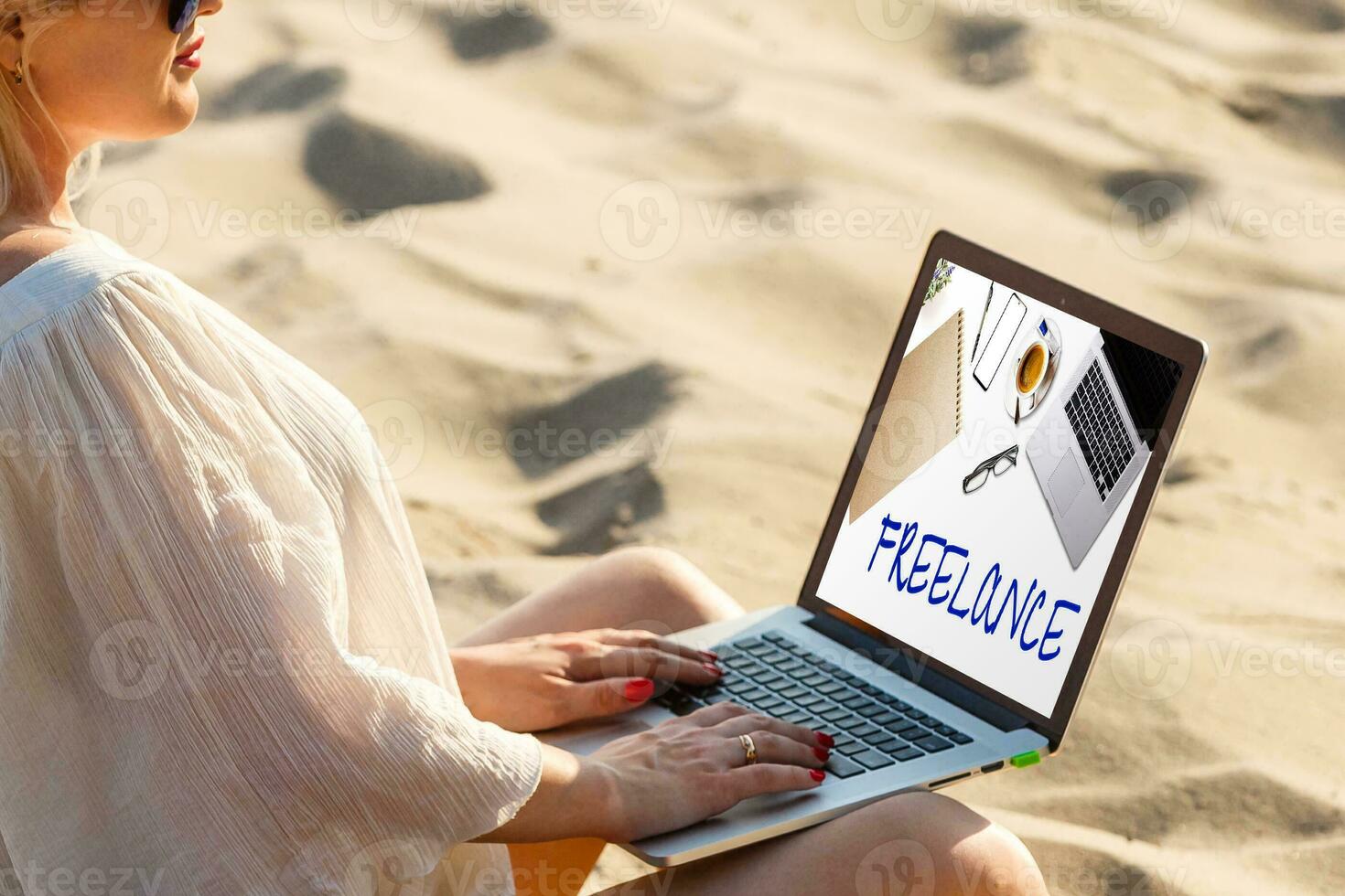 happy freelancer with laptop computer working on the beach, freelance work concept, dream office job workplace photo