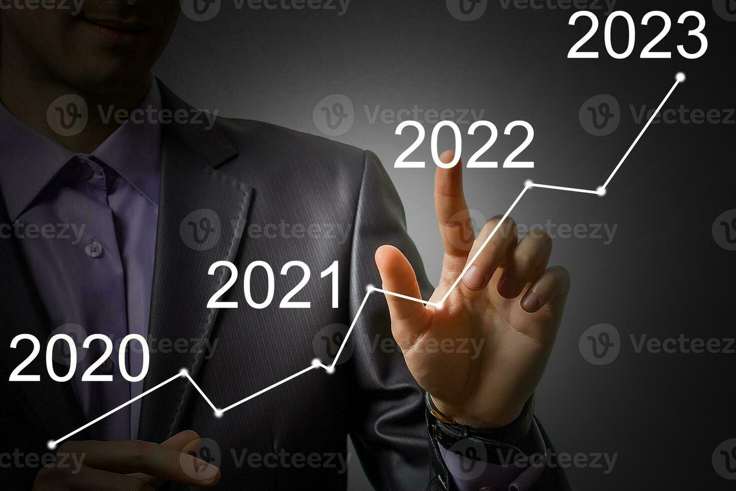 Man's hand pointing graph of success in 2022 year. Growing business concept photo