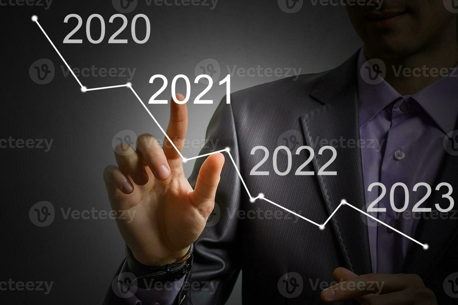 Man's hand pointing graph of success in 2021 year. Growing business concept photo
