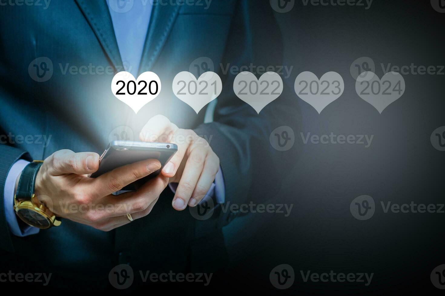 Man holding smartphone in hand display luminous 2020 number calendar year, connecting line virtual holographic glowing in background. global technology concept. photo