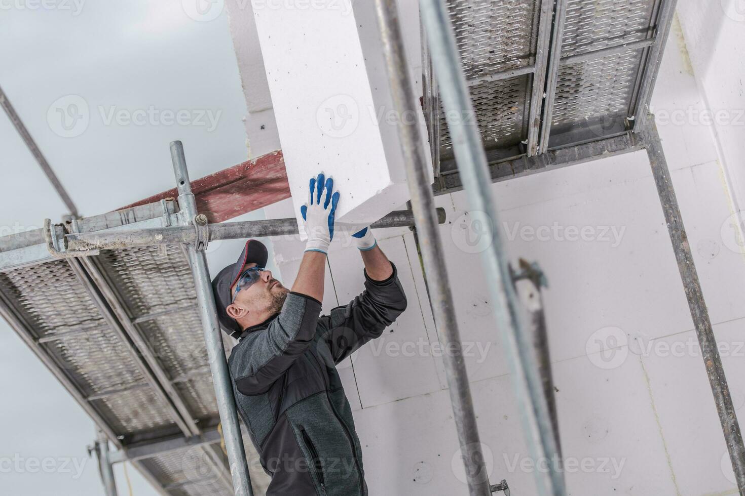 Installation Of Insulating Foam Boards On Outside Walls Of House. photo