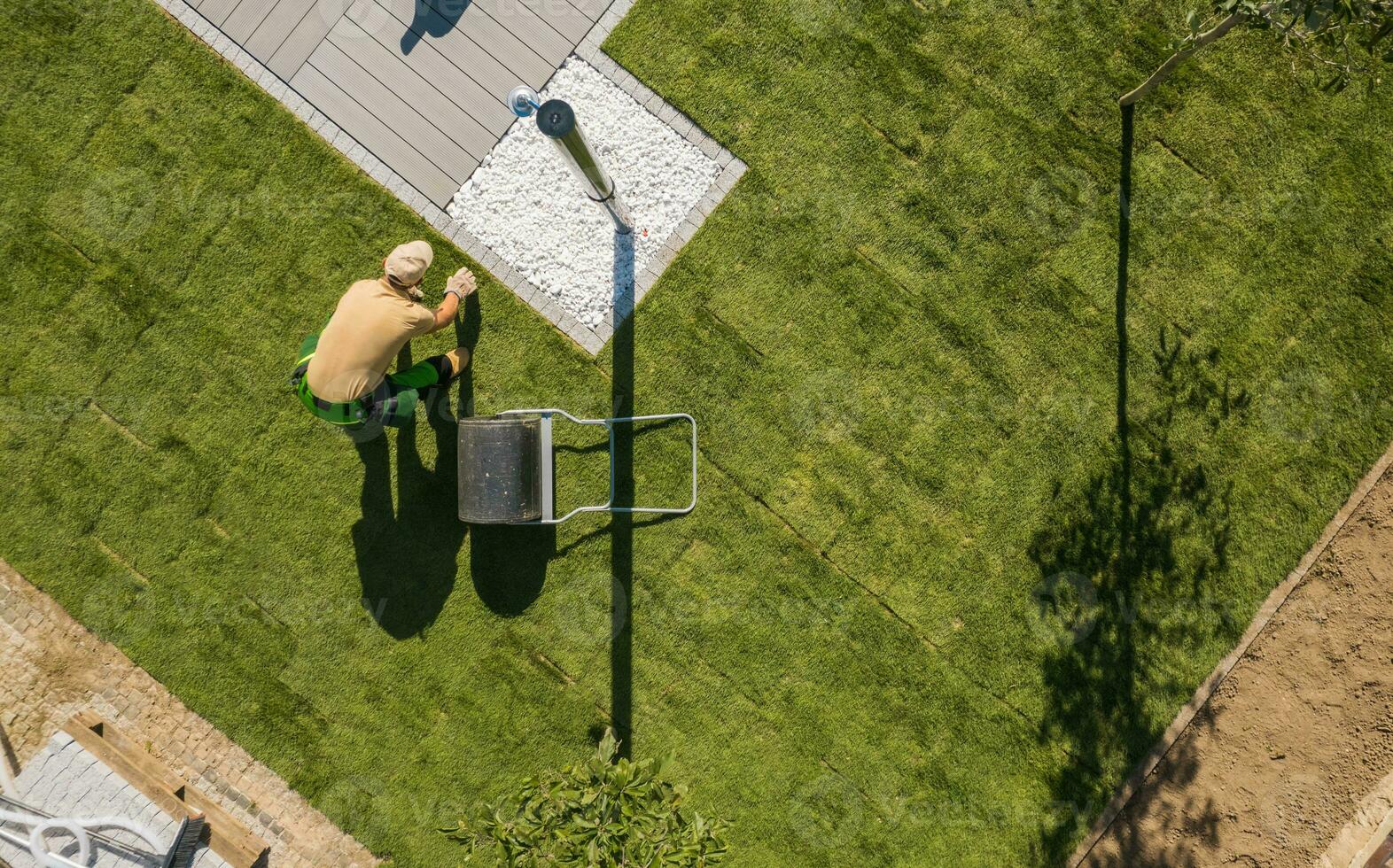 Aerial View of Natural Grass Turfs Installation in a Backyard Garden photo