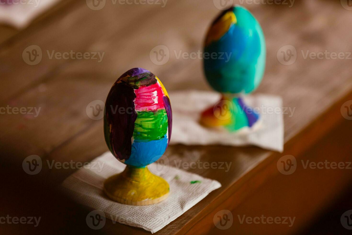 easter, family, holiday and child concept - close up of little girl and mother coloring eggs for easter photo