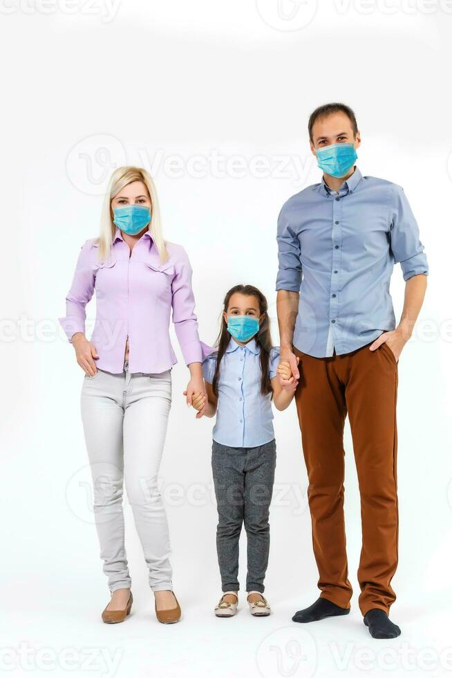 family in protective masks quarantined. Normal life with coronavirus. Lifestyle COVID-19. Quarantine virus protection sterility home together heart symbol photo