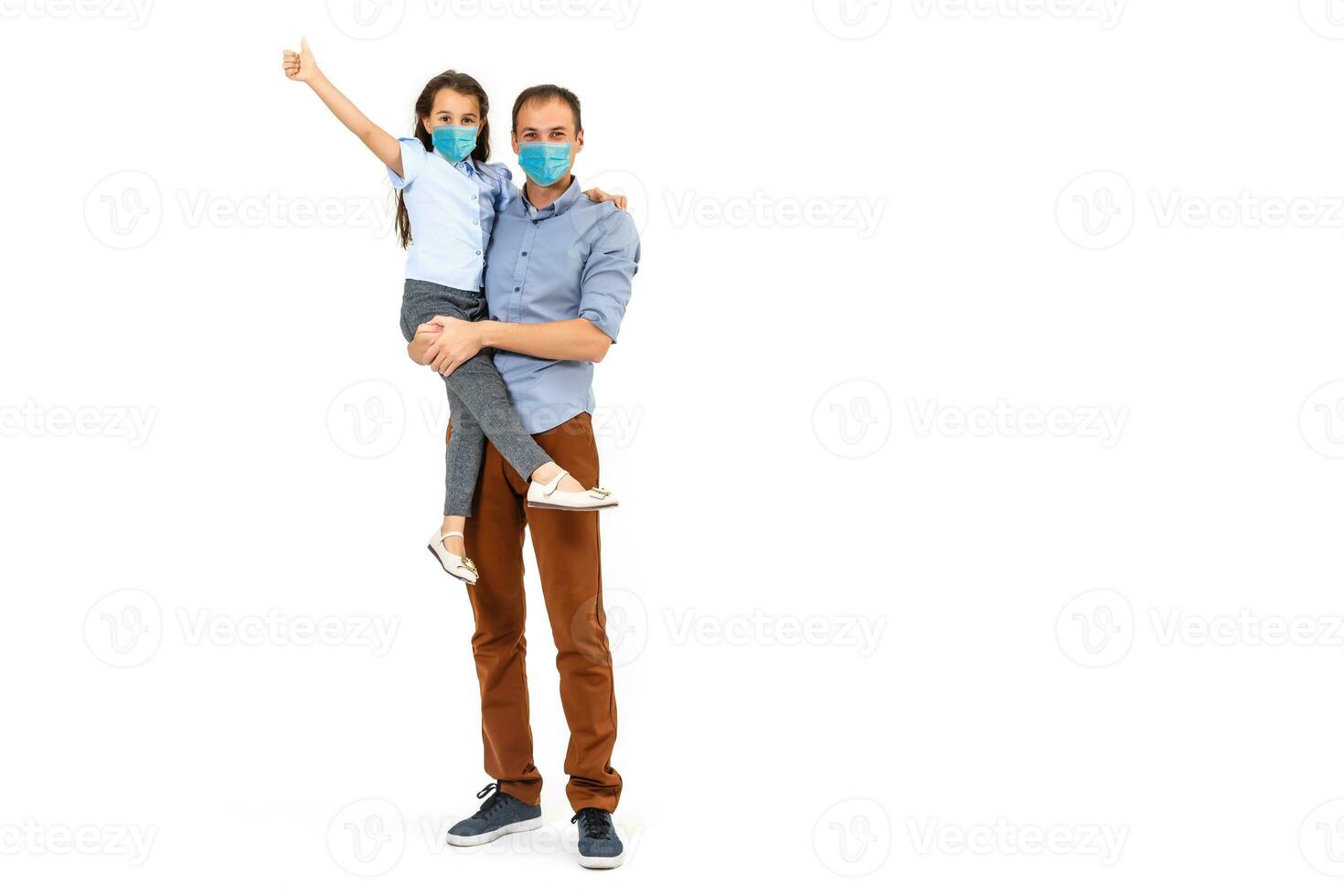 family in protective masks quarantined. Normal life with coronavirus. Lifestyle COVID-19. Quarantine virus protection sterility home together heart symbol photo