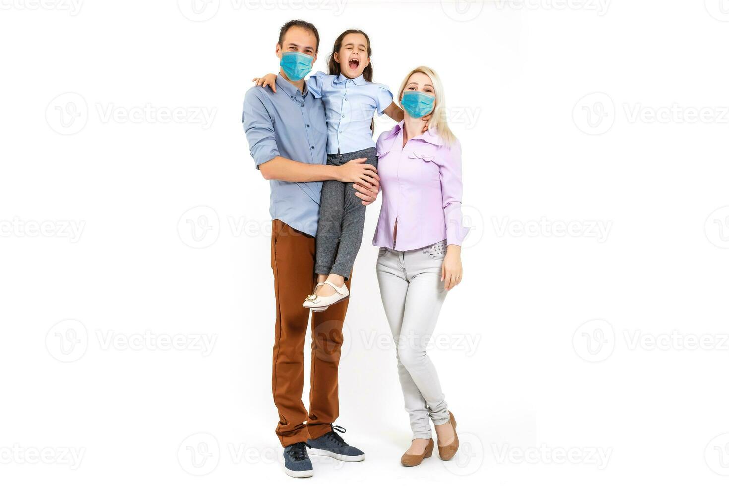 family in protective masks quarantined. Normal life with coronavirus. Lifestyle COVID-19. Quarantine virus protection sterility home together heart symbol photo