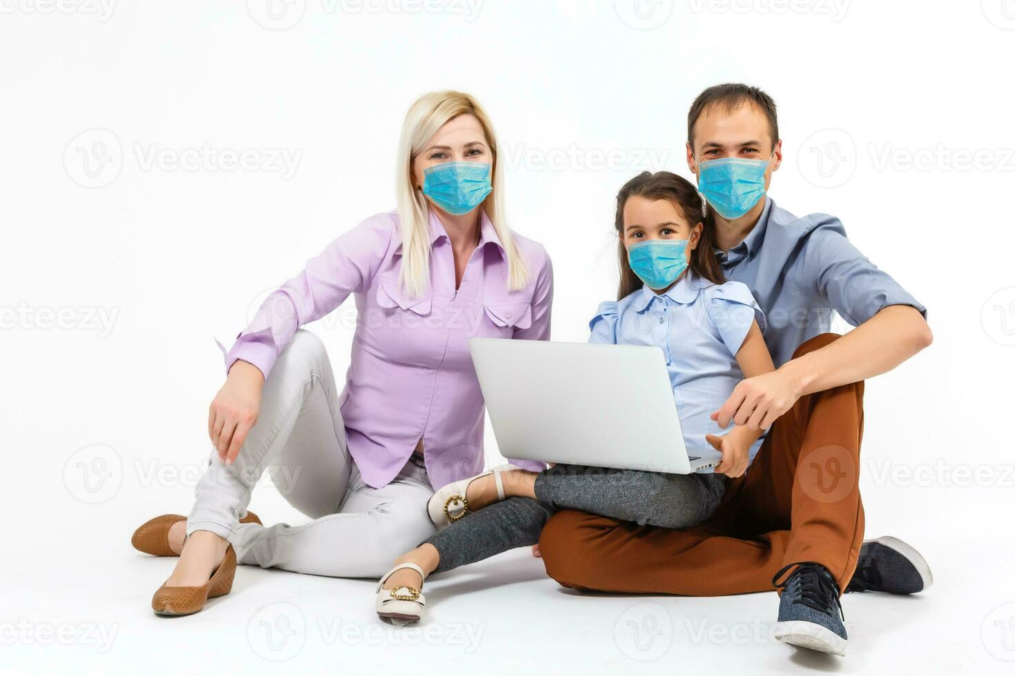 family in protective masks quarantined. Normal life with coronavirus. Lifestyle COVID-19. Quarantine virus protection sterility home together heart symbol photo