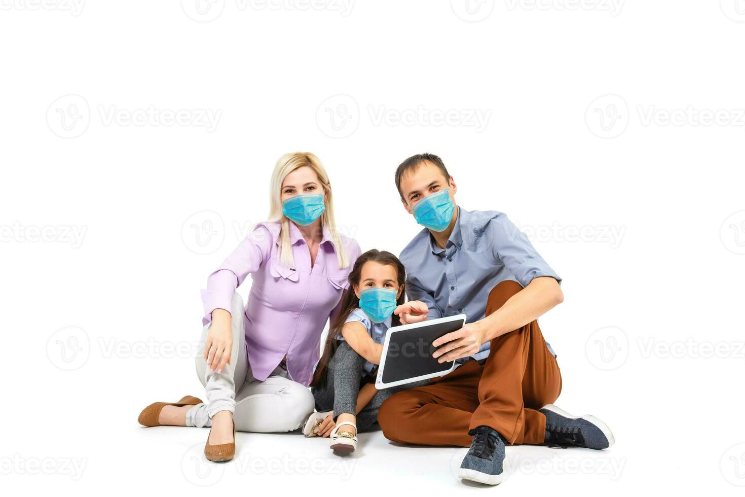 family in protective masks quarantined. Normal life with coronavirus. Lifestyle COVID-19. Quarantine virus protection sterility home together heart symbol photo