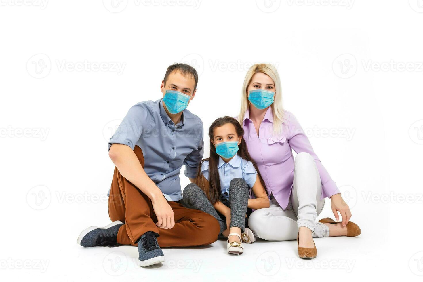 family in protective masks quarantined. Normal life with coronavirus. Lifestyle COVID-19. Quarantine virus protection sterility home together heart symbol photo